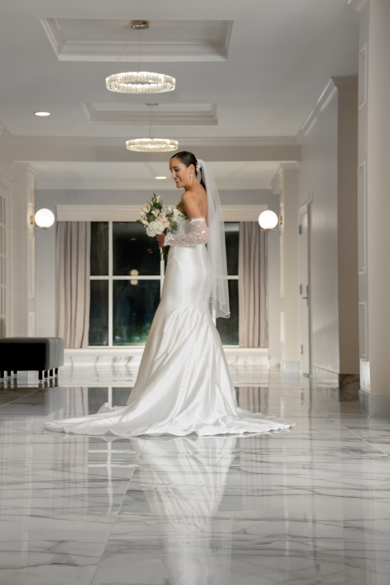 Bride standing beside a courtyard window