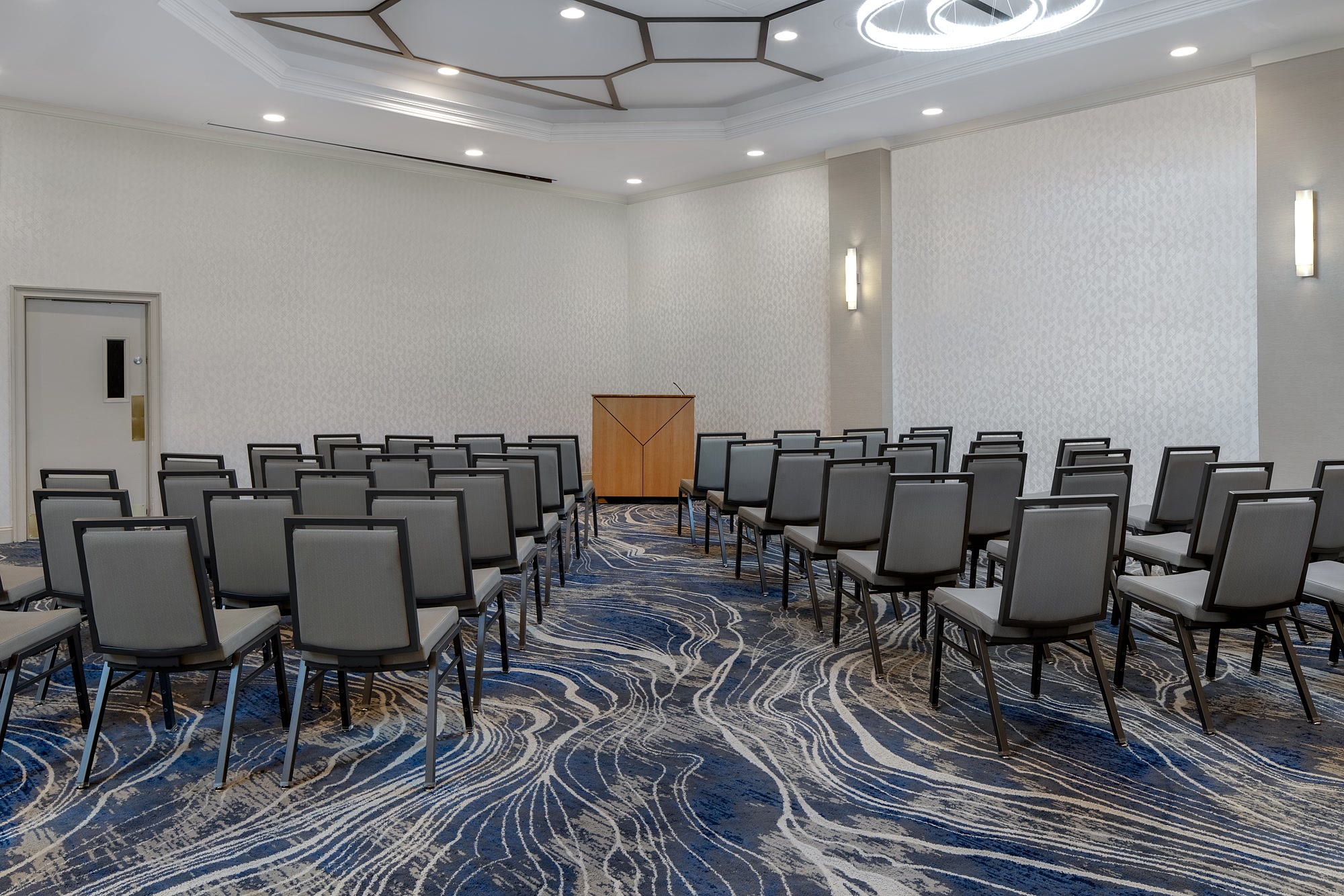 The Garden Room set theater style with rows of chairs facing a lectern