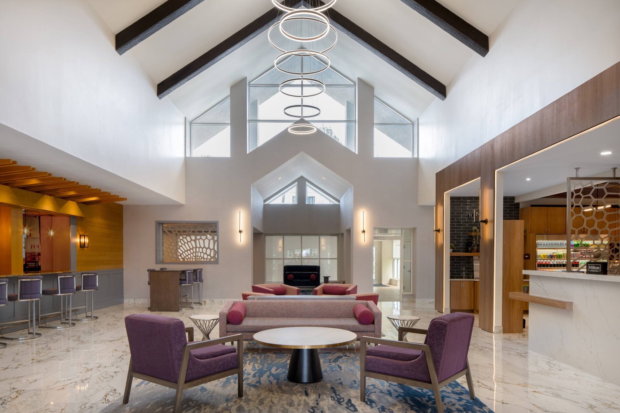 Open hotel lobby atrium with seating and skylights