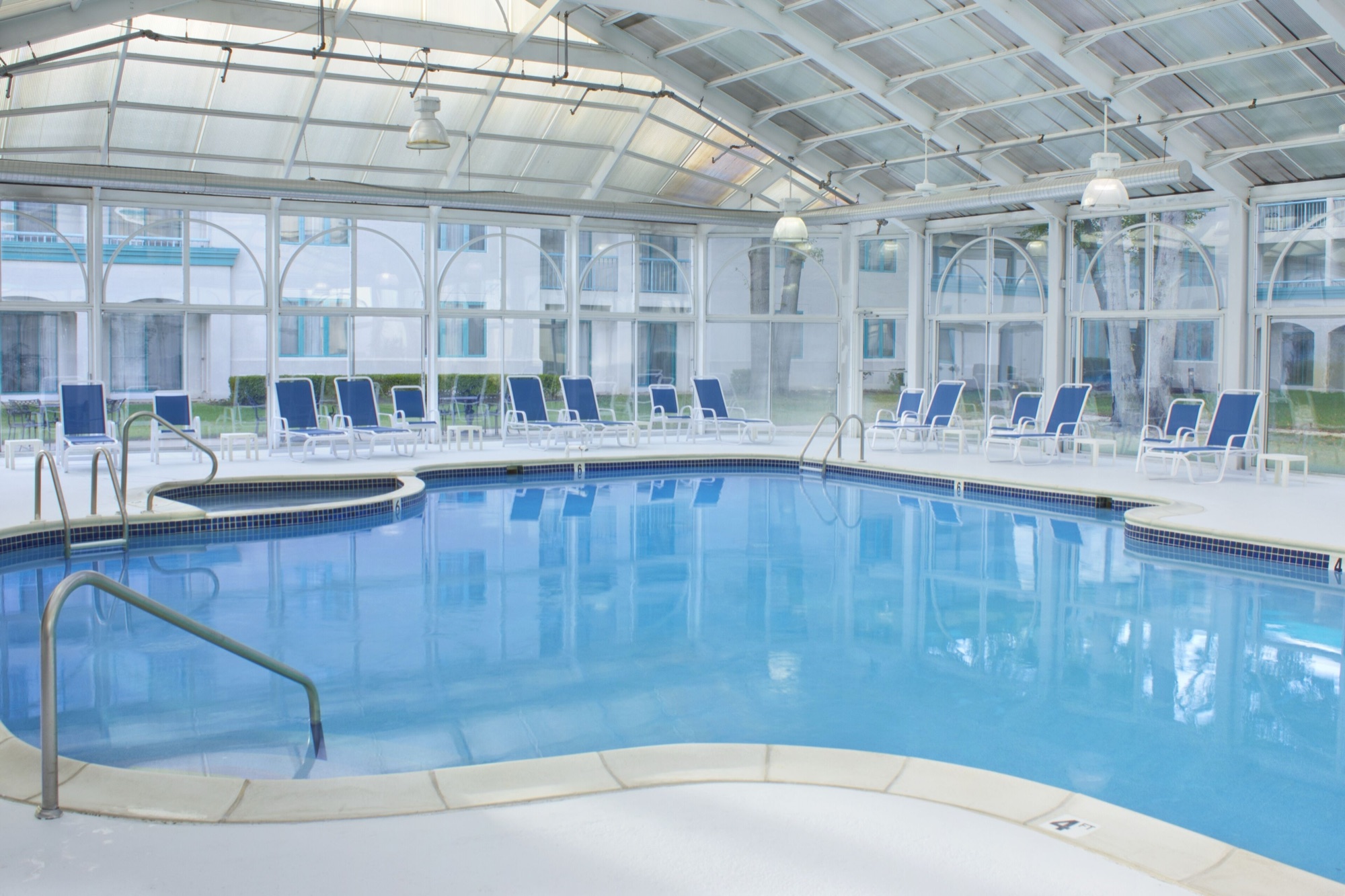 Indoor hotel pool with courtyard windows